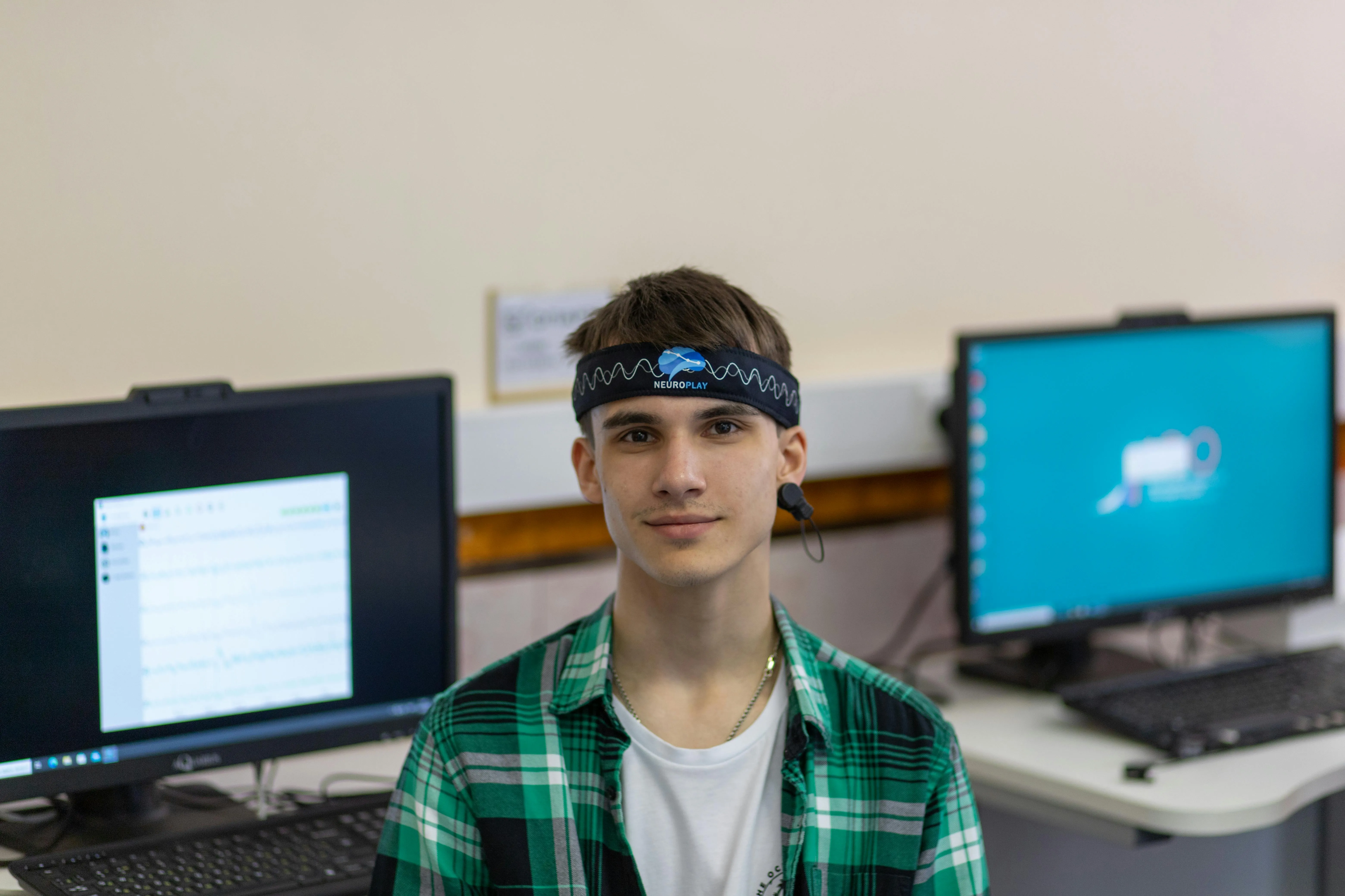 Young participant wearing NeuroPlay EEG headband in a research lab